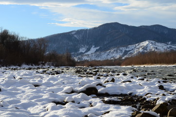 winter landscape in the forest with snow and blue sky and river