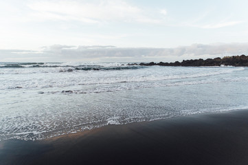 Fototapeta premium Fantastically beautiful sunset on the north coast of Tenerife, a beach with stones and black sand.