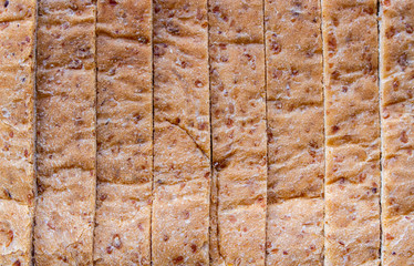 Surface of Whole wheat bread background with seam pattern. Texture of Whole grain bread.