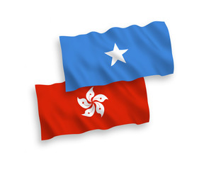National vector fabric wave flags of Somalia and Hong Kong isolated on white background. 1 to 2 proportion.