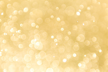 Gold particle background with soft blur light effect.