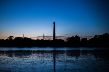 Obraz premium industrial factory at sunset