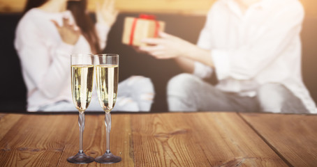 Man giving happy birthday present to his girlfriend in cafe