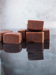 Chocolate fudge on reflective surface.