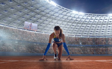 Athlete woman on the starting blocks on sport championship.