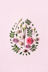 Easter egg shape made of flowers, leaves and quail eggs. Minimal holiday concept. Natural Floral pattern - obrazy, fototapety, plakaty