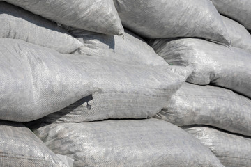 Stack of nylon bags with pebble. Fortification wall. Winter storm and flood defense protection