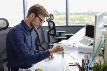 Shot of a handsome male architect working on a design in his office.