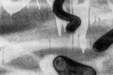 Poster Im Rahmen Schöner Schwarzweiss-Straßenkunst-Graffitihintergrund. Die Wand ist mit abstrakten Zeichnungen Hausfarbe verziert. Urbane Kultur der Straßenjugend im modernen Stil. Abstraktes Bild an der Wand © Yaroslav