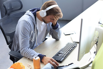 Young upset gamer playing online video games on computer and feel depressed.
