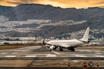 airplae landing in airport, nearly the city in the morning