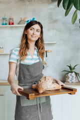 Stylish housewife resting after cooking in a cozy kitchen