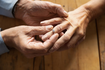 Man makes marriage proposal to woman putting marriage ring