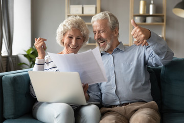 70s spouses check documents feels happy about pay debt off