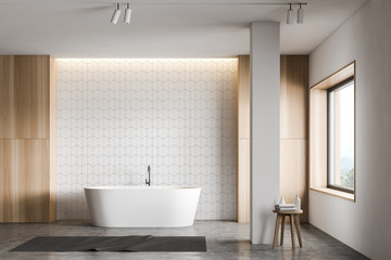 Fototapeta na wymiar White tile and wood bathroom with tub and column