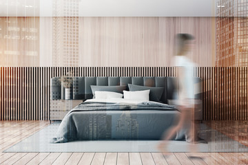 Woman walking in wooden master bedroom