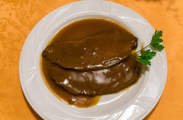 Close up roasted beef with gravy sauce.