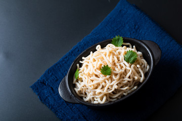 Healthy food concept organic Noodle or spaghetti Shirataki Konjac in black ceramic cup with copy space