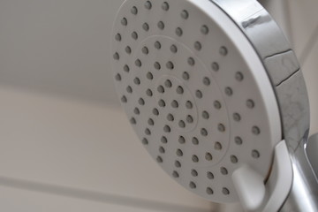 Shower Head. A shower from which water pours.