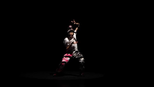Professional young hip-hop dancer, dancing in dark studio in the fog. Hip hop culture. Rehearsal. Contemporary.