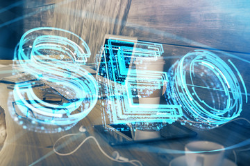 Multi exposure of table with computer and seo drawing hologram. Search optimization concept.