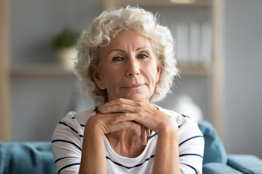 Headshot portrait mature woman posing looking at camera