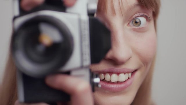 White woman smiling before taking photograph in slow motion