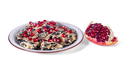 Traditional georgian eggplant dish with walnut and pomegranate on the plate.