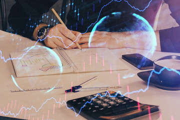 Double exposure of man doing analysis of stock market with forex graph.