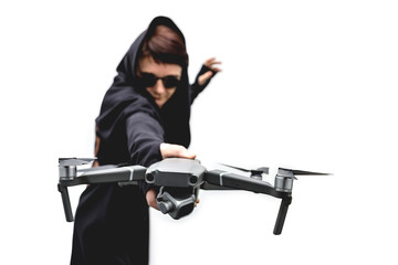 Fototapeta na wymiar female spy in black clothes and round glasses with a drone isolated on white background