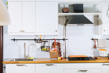 White interior kitchen facade and wooden table top