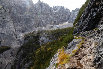 A typical trail in the Dolomites with cables, Sorapis Circuit Trek. A narrow path in the heart of tremendous mountains. The Dolomites, South Tyrol, Italy, 