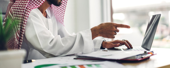 Arabic businessman working with laptop computer.creative arab business people planning at modern...