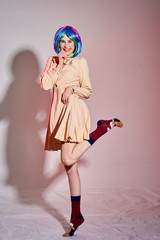 girl in beautiful modern clothes posing in the Studio with objects, mannequin