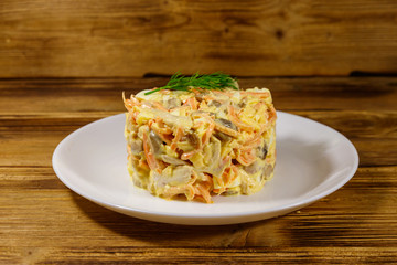 Tasty salad with chicken breast, roasted mushrooms, carrots, grated cheese, eggs and mayonnaise on...