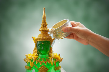 sprinkle water onto the Emerald Buddha in songkran festival