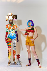 girl in beautiful modern clothes posing in the Studio with objects, mannequin