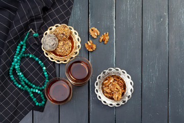 Nut balls dessert served with coffee on dark wooden table, top view