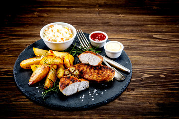 Grilled chicken fillet with baked potatoes and vegetables