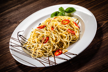 Pasta with chilli on wooden table