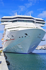 Gigantic white modern cruise ship liner with other ships and windjammer in port of Gran Canaria on...