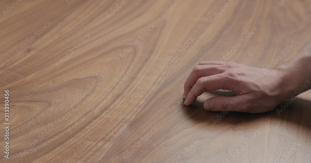 Wall mural man hand finger tapping on black walnut table - Wall murals