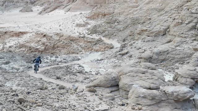 Mountain biker in the desert in Timna Park. Single Bike Track in the Israeli Desert.