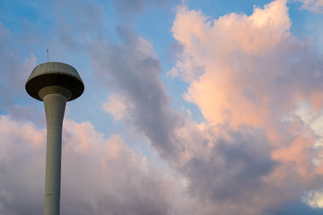 Elevated Water Tank against sunset sky.