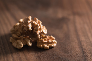 Walnuts kernels on walnut wood board with copy space