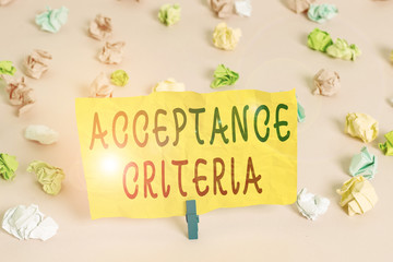 Handwriting text writing Acceptance Criteria. Conceptual photo Specified indicators in assessing the ability of a part Colored crumpled papers empty reminder pink floor background clothespin