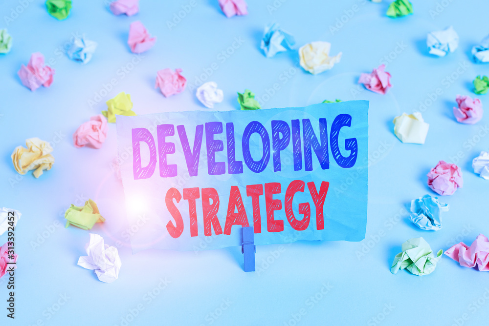 Poster word writing text developing strategy. business photo showcasing game plan that sets specific goals 