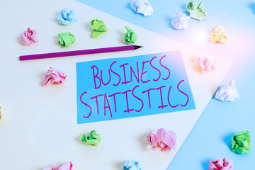 Writing note showing Business Statistics. Business concept for Science of intelligent decision making in the business Colored crumpled papers empty reminder blue yellow clothespin