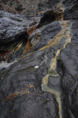 Minerals leaching out of the slate at Tregardock Beach Cornish Coast