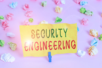 Handwriting text writing Security Engineering. Conceptual photo focus on the security aspects in the design of systems Colored crumpled papers empty reminder pink floor background clothespin